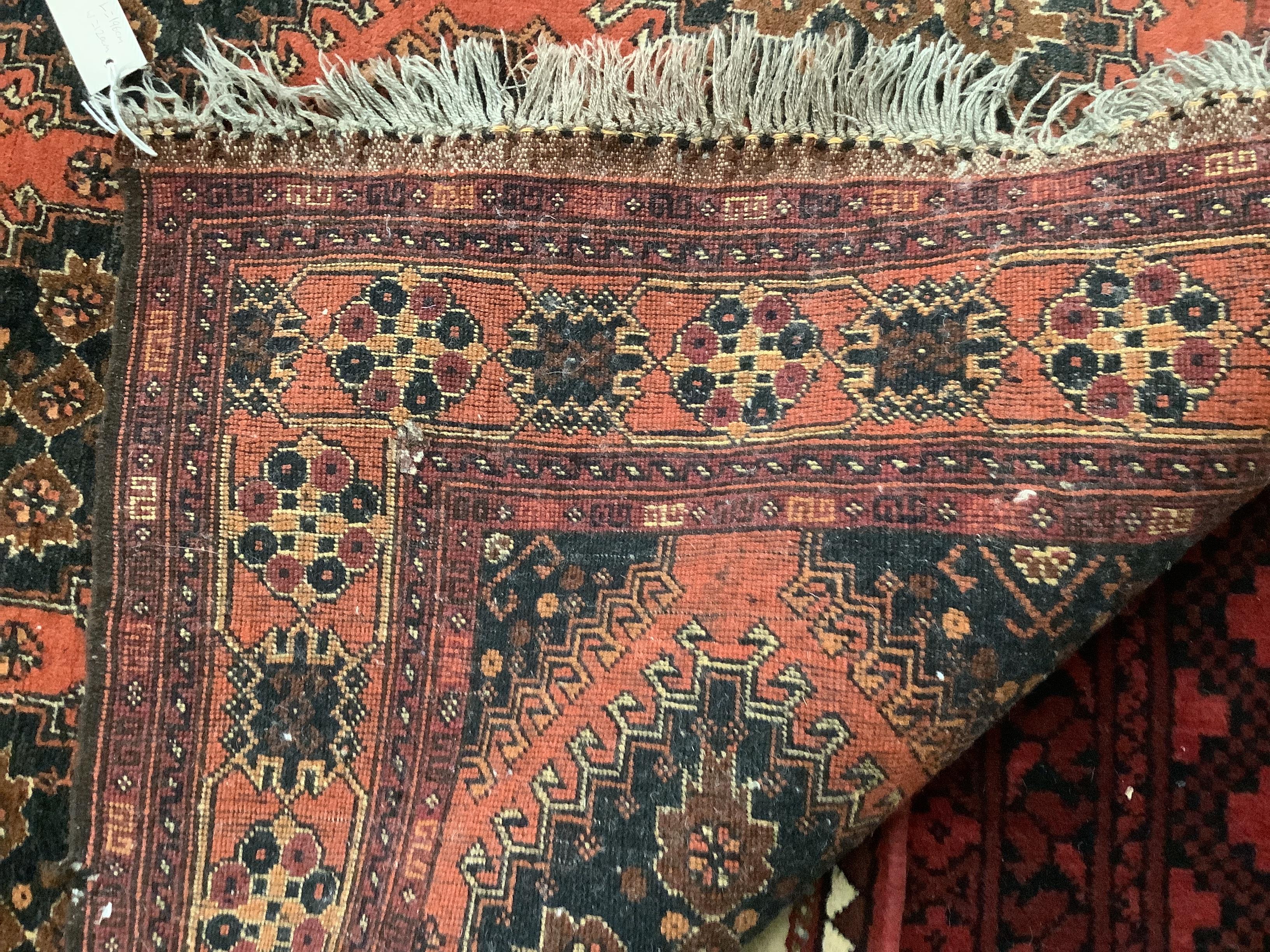 A Caucasian brick red ground rug, 196 x 120cm and a cotton pile Bokhara rug, 193 x 128cm